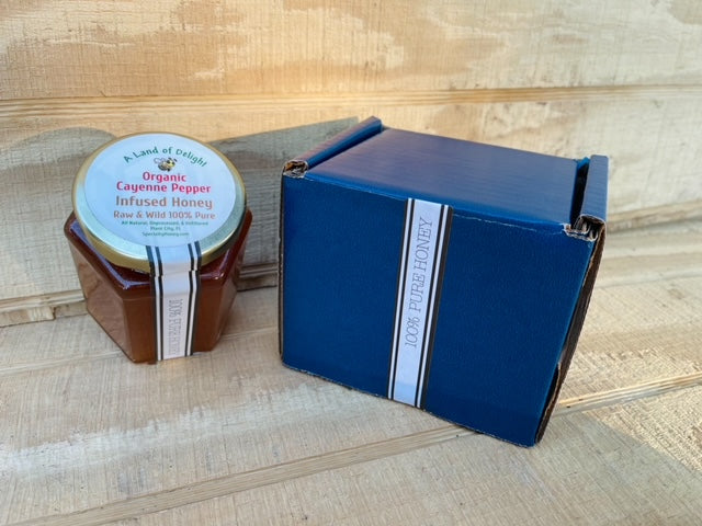 Specialty Gourmet Honey: Organic Cayenne Infused Raw Honey - 12oz Jar Next to Blue Gift Box