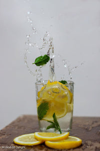 Meyers Lemon Slices Splashing into glass of water