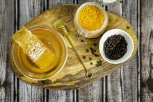 Load image into Gallery viewer, Honey In Bowl On Cutting Board with Turmeric and Black Pepper Beside it
